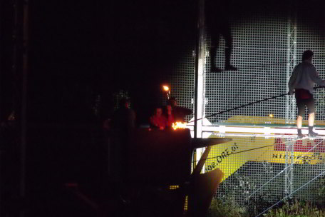 Olympic flame is balanced upwards on a rope